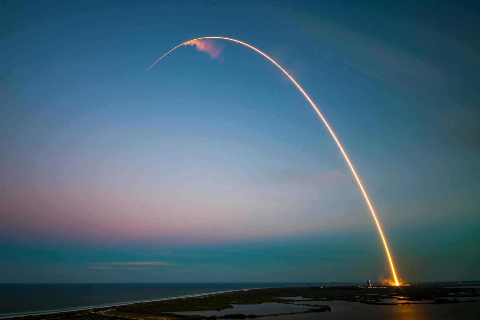 Rocket launchpad with digital Bitcoin symbol overlay
