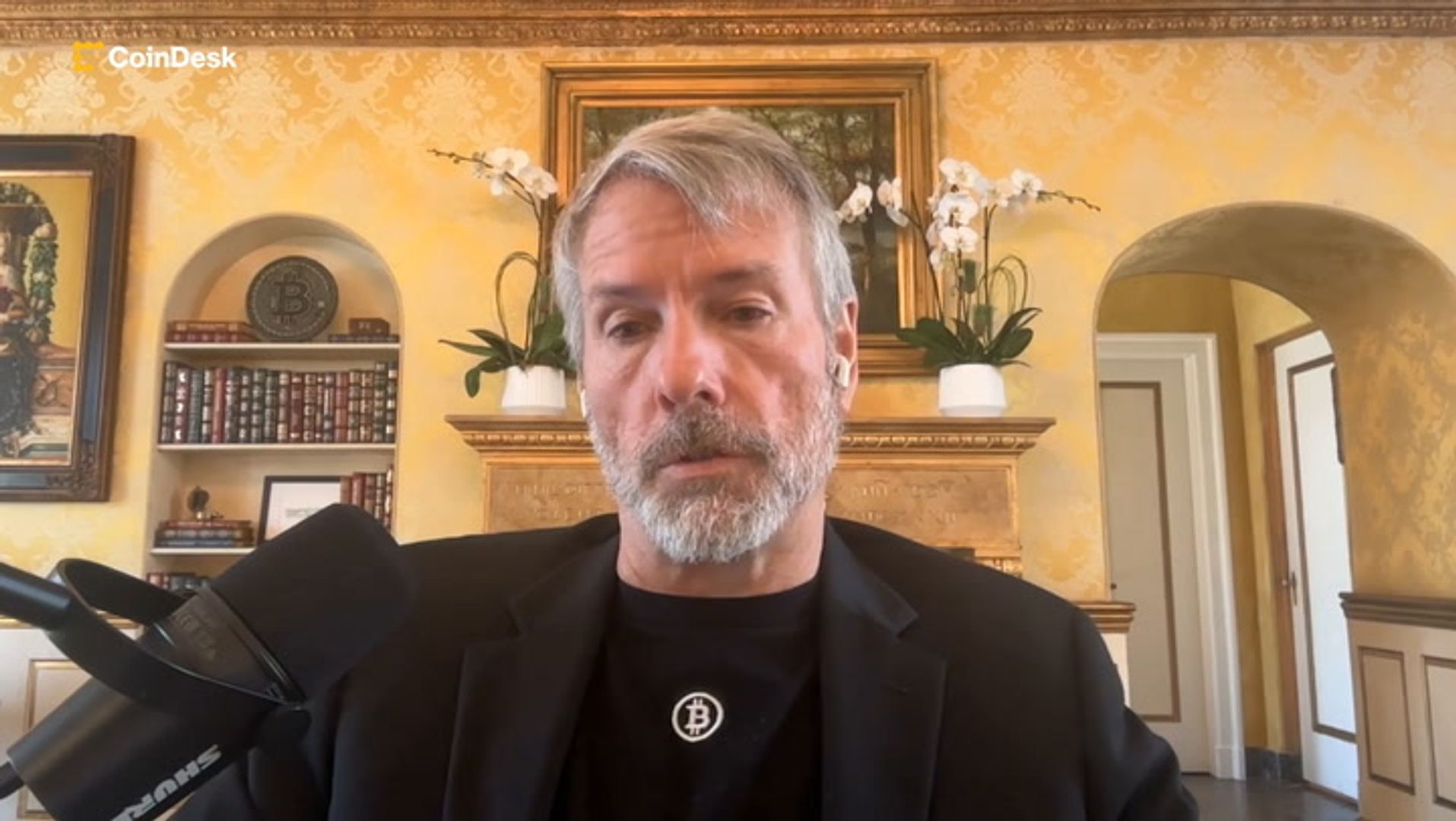 Executive holding bitcoin icons with chart in background